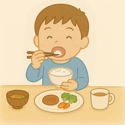 正しい姿勢と食器の持ち方で食べる子